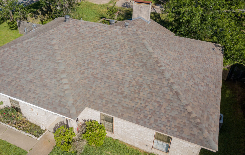 Aerial photo of a completed roofing job with Malarkey Vista natural wood shingles by Sustainable Roofing a Brazos Valley Roofing Company