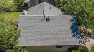 Grey Malarkey Roofing shingles on a completed roof from an overhead vantage point - College Station Roofer Sustainable Roofing