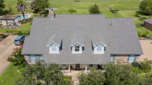 Overhead photo of a ranch style home with a new gray colored roof - College Station Roofing Companies in Texas - Sustainable Roofing LLC