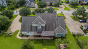 Aerial photo of a home before a roof replacement in College Station, TX - Roof Replacement Brazos Valley Sustainable Roofing